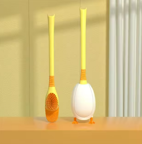Yellow toilet brush with orange bristles and cute duck stand