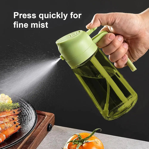 Green oil sprayer bottle spraying a fine mist of olive oil over food for air fryer cooking